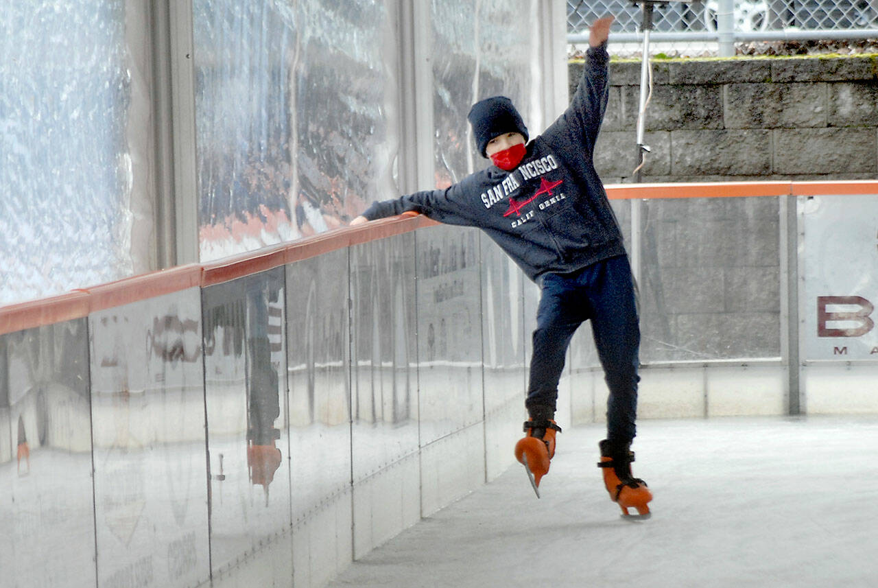 Joshua Wakefield, 11, of Sequim tries to keep his balance while learning the fine nuances of ice skating on Fridays opening day of the Port Angeles Winter Ice Village in downtown Port Angeles. The village will be open for skating daily from 9 a.m. to 9 p.m. with breaks for ice resurfacing through Jan. 3. (Keith Thorpe/Peninsula Daily News)