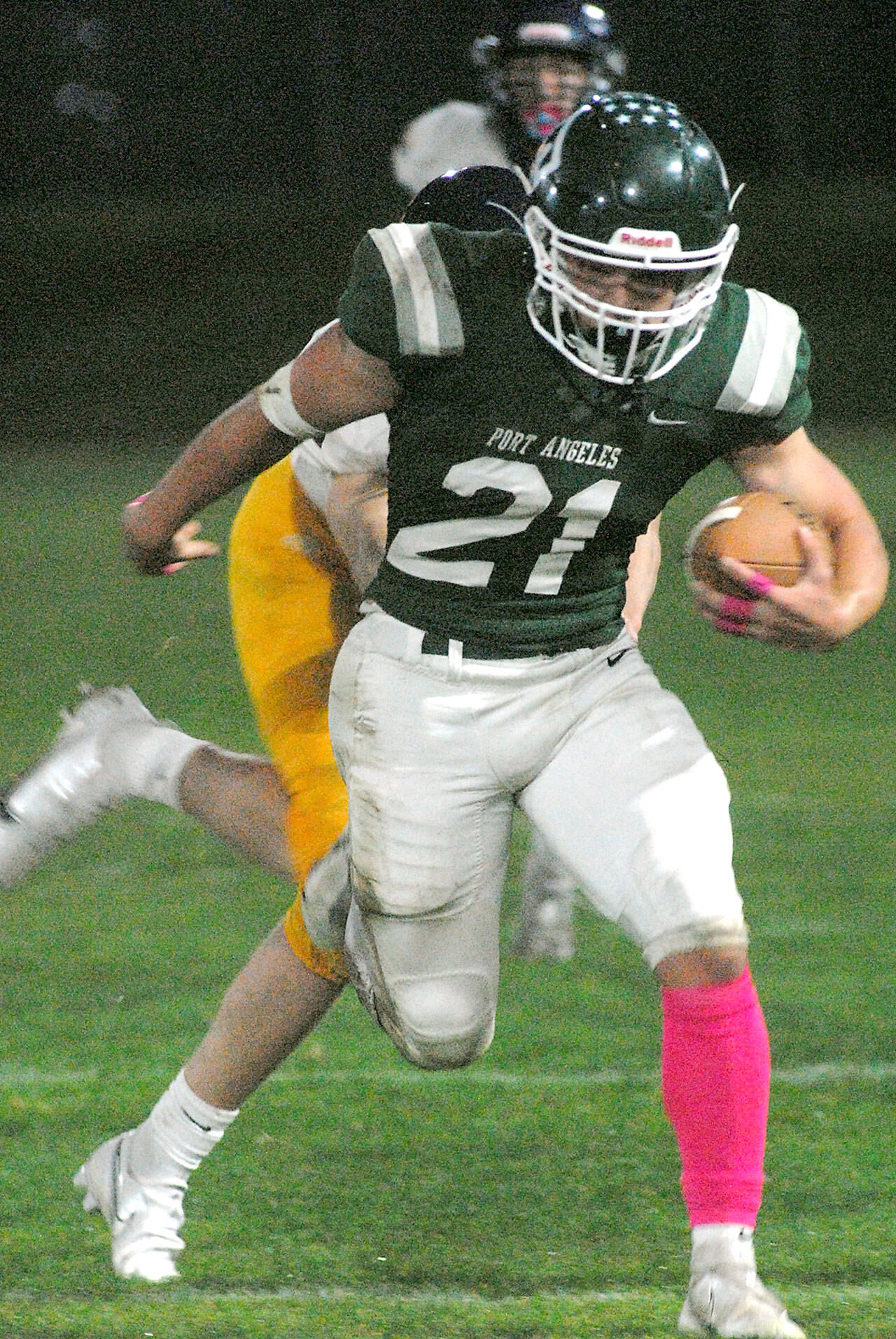Keith Thorpe/Peninsula Daily News
Port Angeles' Daniel Cable escapes the Bainbridge defense on Friday night at Port Angeles Civic Field.