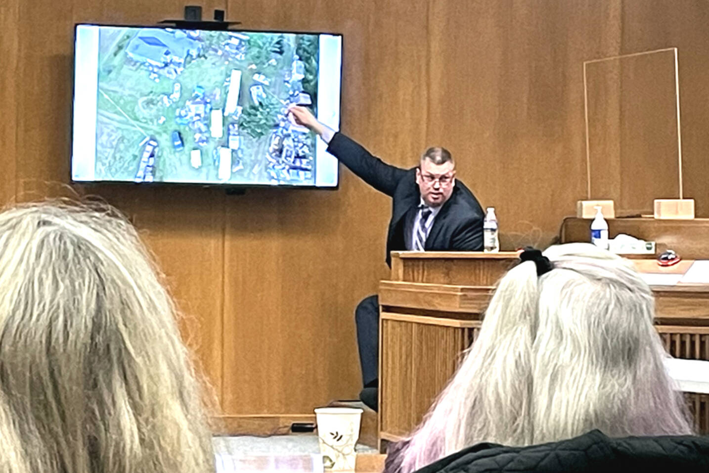 State Patrol Detective Michael Welander displays drone photographs from a triple-murder investigation from Jan. 1, 2019. (Rob Ollikainen/for Peninsula Daily News)