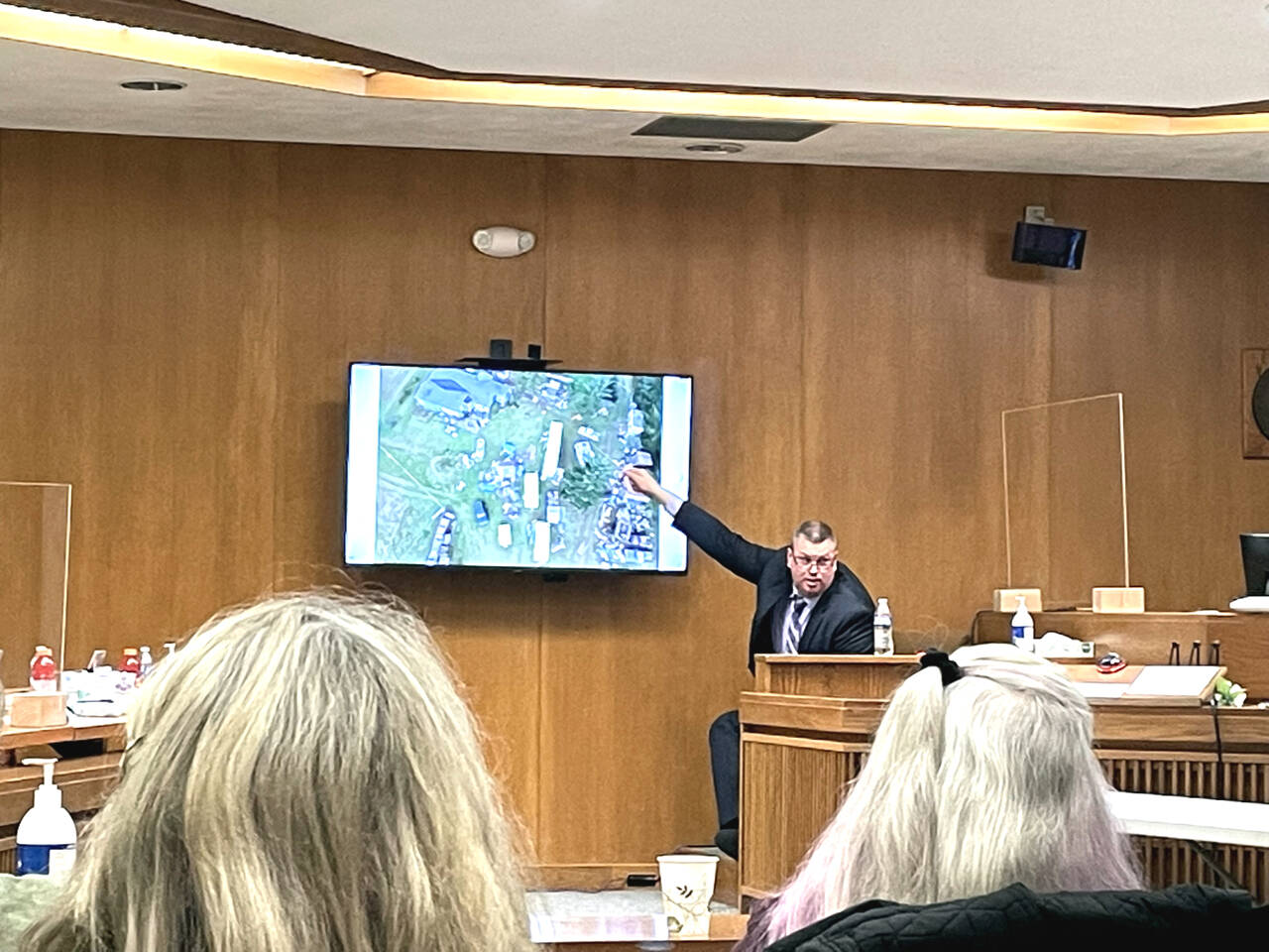 State Patrol Detective Michael Welander displays drone photographs from a triple-murder investigation from Jan. 1, 2019. (Rob Ollikainen/for Peninsula Daily News)
