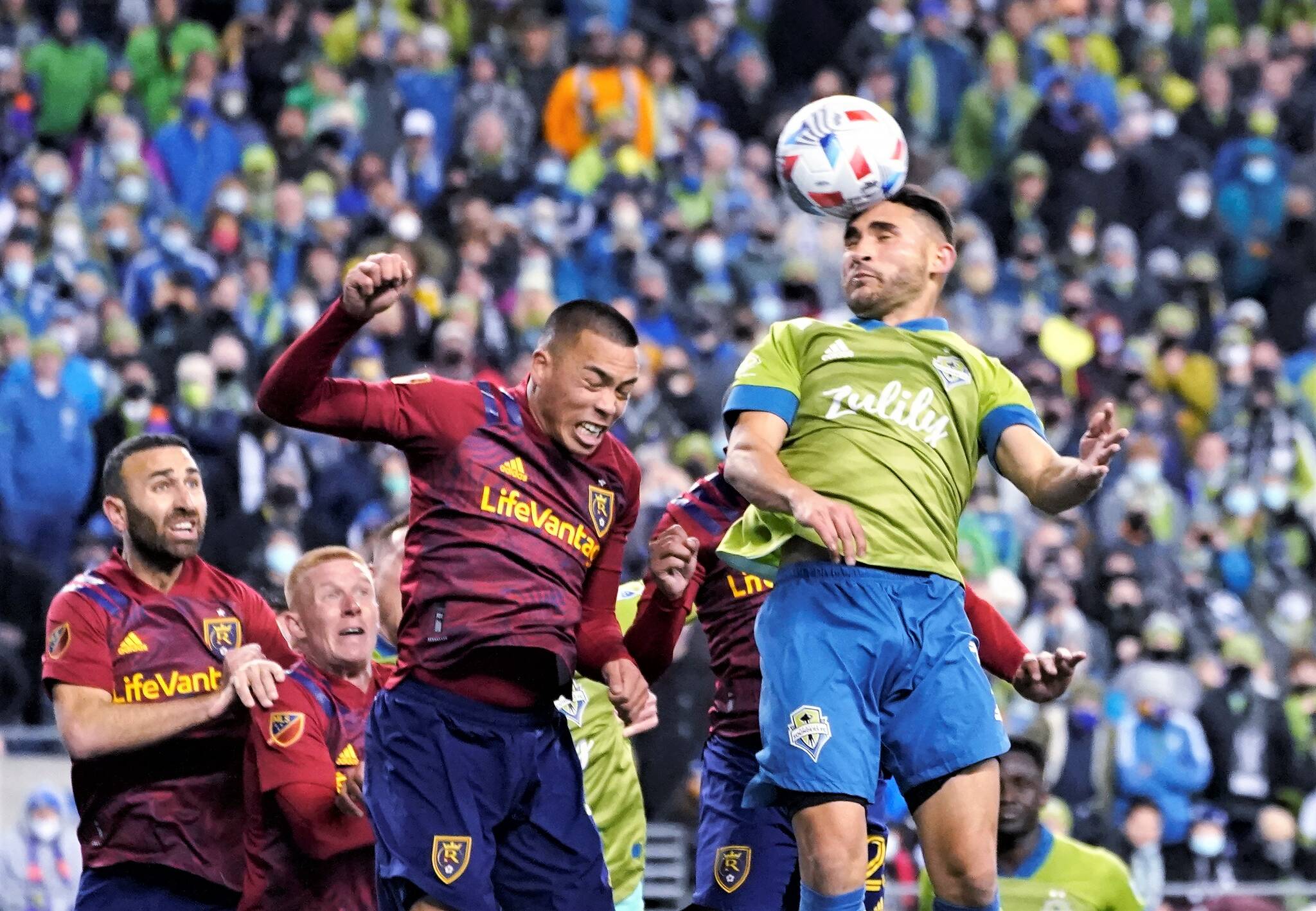 Seattle Sounders’ Cristian Roldan, right, heads the ball on a corner kick against Real Salt Lake during the second half of an MLS first-round playoff soccer match Tuesda in Seattle. (AP Photo/Ted S. Warren)