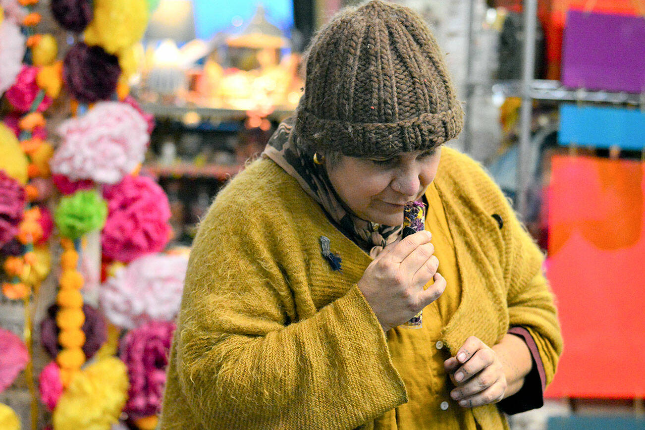 Artist Lisa Leporati checks the fragrance of her flower confetti, one of the items she'll offer during the Handwork Market, an artists' showcase at the Cotton Building in downtown Port Townsend on Saturday. Diane Urbani de la Paz/Peninsula Daily News
