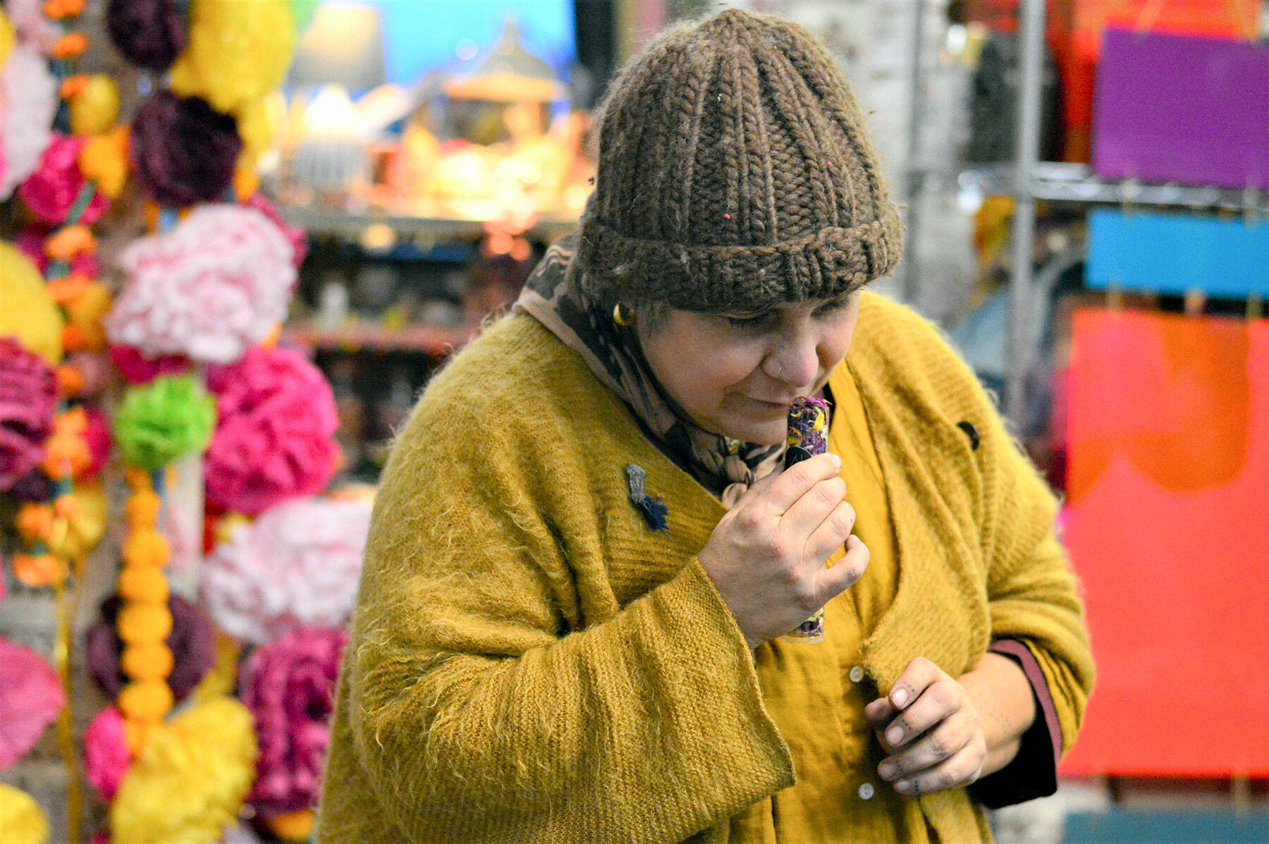 Artist Lisa Leporati checks the fragrance of her flower confetti, one of the items she’ll offer during the Handwork Market, an artists’ showcase at the Cotton Building in downtown Port Townsend on Saturday. (Diane Urbani de la Paz/Peninsula Daily News)
