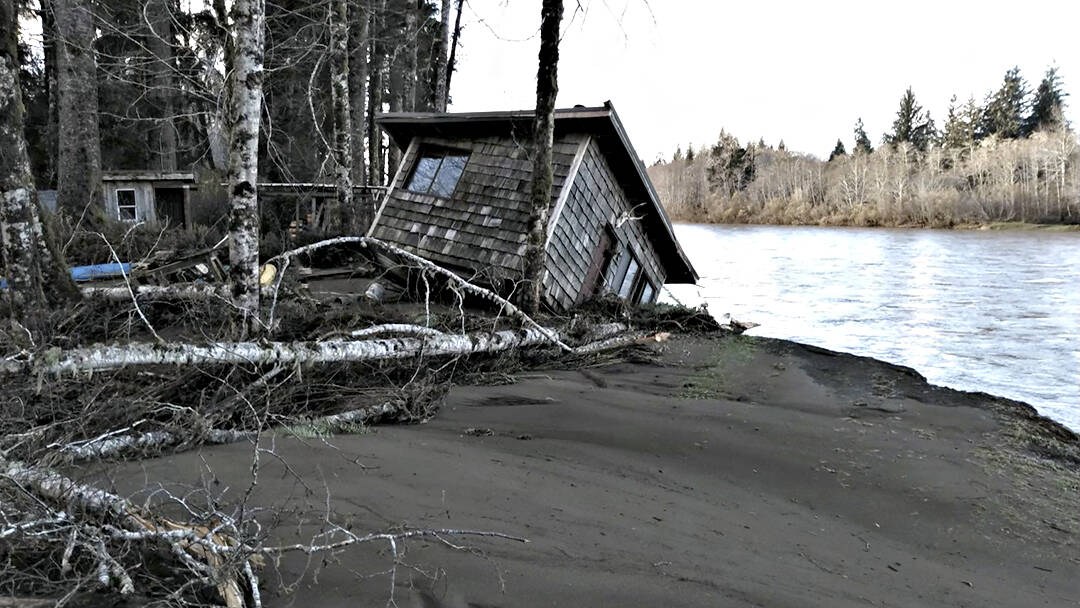 Chip Keen 

A cabin teeters on the bank of the Quillayute River after storms inundated the region with heavy rain.