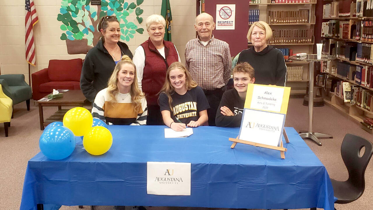 Alex Schmadeke of Sequim High School signs a letter of intent to attend Augustana University in Sioux Falls, S.D. and compete in acro and tumbling. At her signing is her mother Kate Schmadeke, seated left and Zeke Schmadeke, seated right. Standing, from left, is coach Kelle Riley, grandmother Linda Swanson and grandparents Richard and Kathy Schmadeke. Alex also recognized her father Brent Schmadeke, who was not able to attend. (Sequim High School)