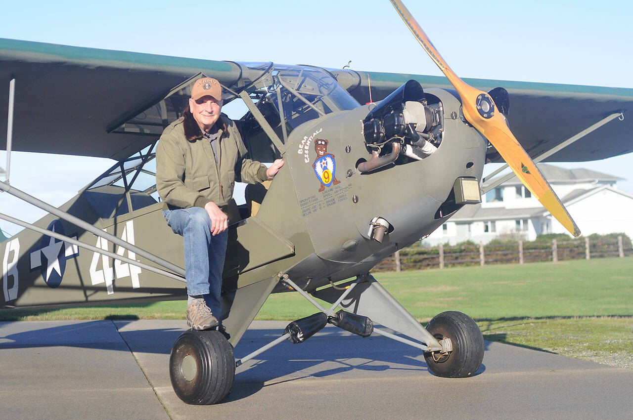 Sequim pilot and veteran David Woodcock stands near his 1944 Piper Cub L-4H, an aircraft that saw action at the Battle of the Bulge. (Michael Dashiell/Olympic Peninsula News Group)