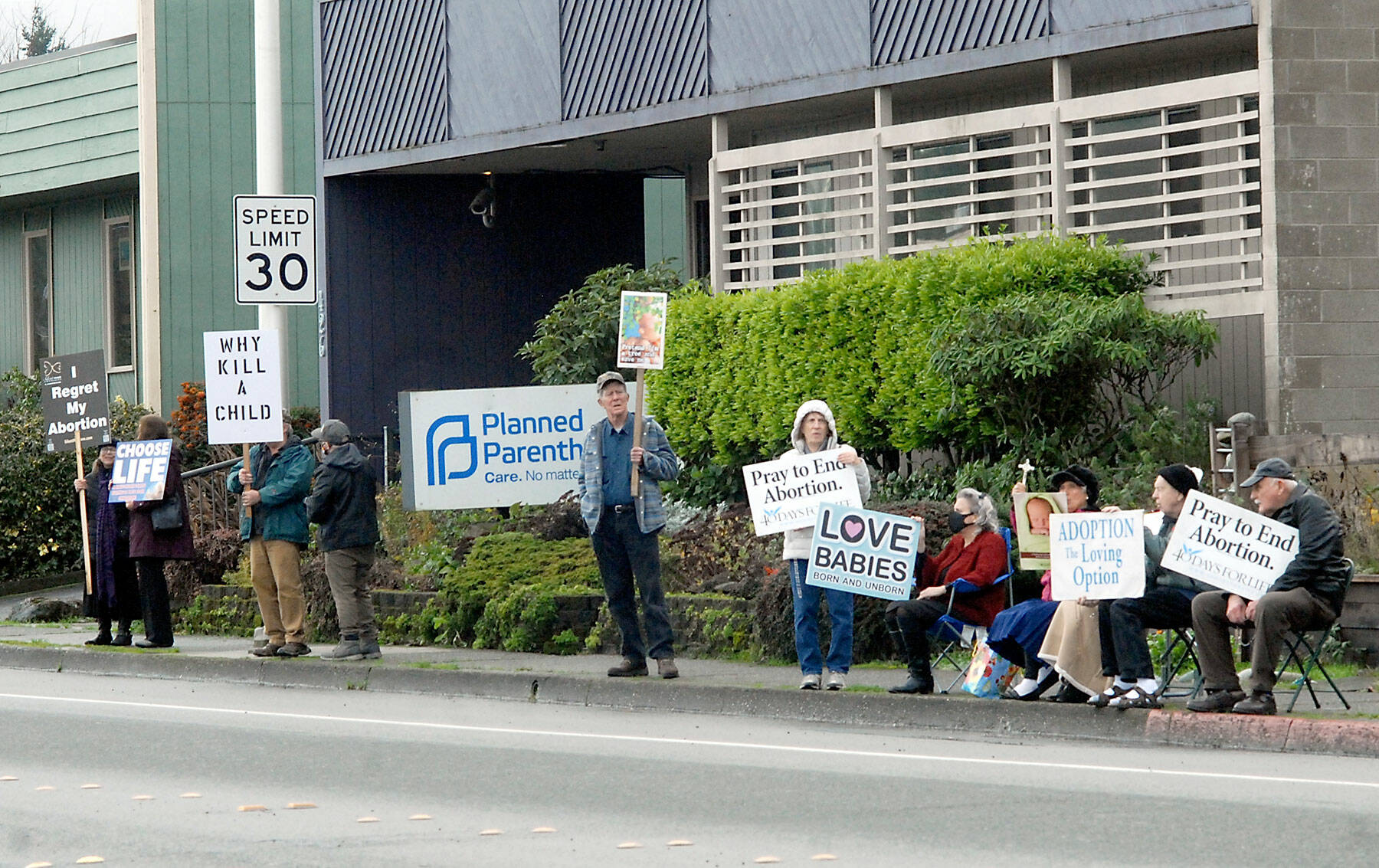 Pro-life protesters hold signs in front of the Planned Parenthood clinic on Eighth Street in Port Angeles. (Keith Thorpe/Peninsula Daily News)