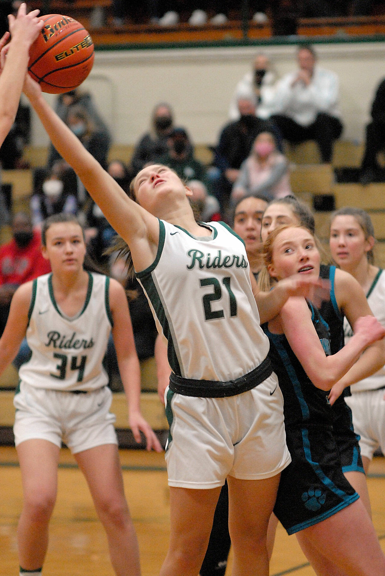 Keith Thorpe/Peninsula Daily News Port Angeles’ Jayde Gedelman, front, battles for a rebound as teammate Lexie Smith, left, and the Bonney Lake defense look on during Saturday’s game at Port Angeles High School.