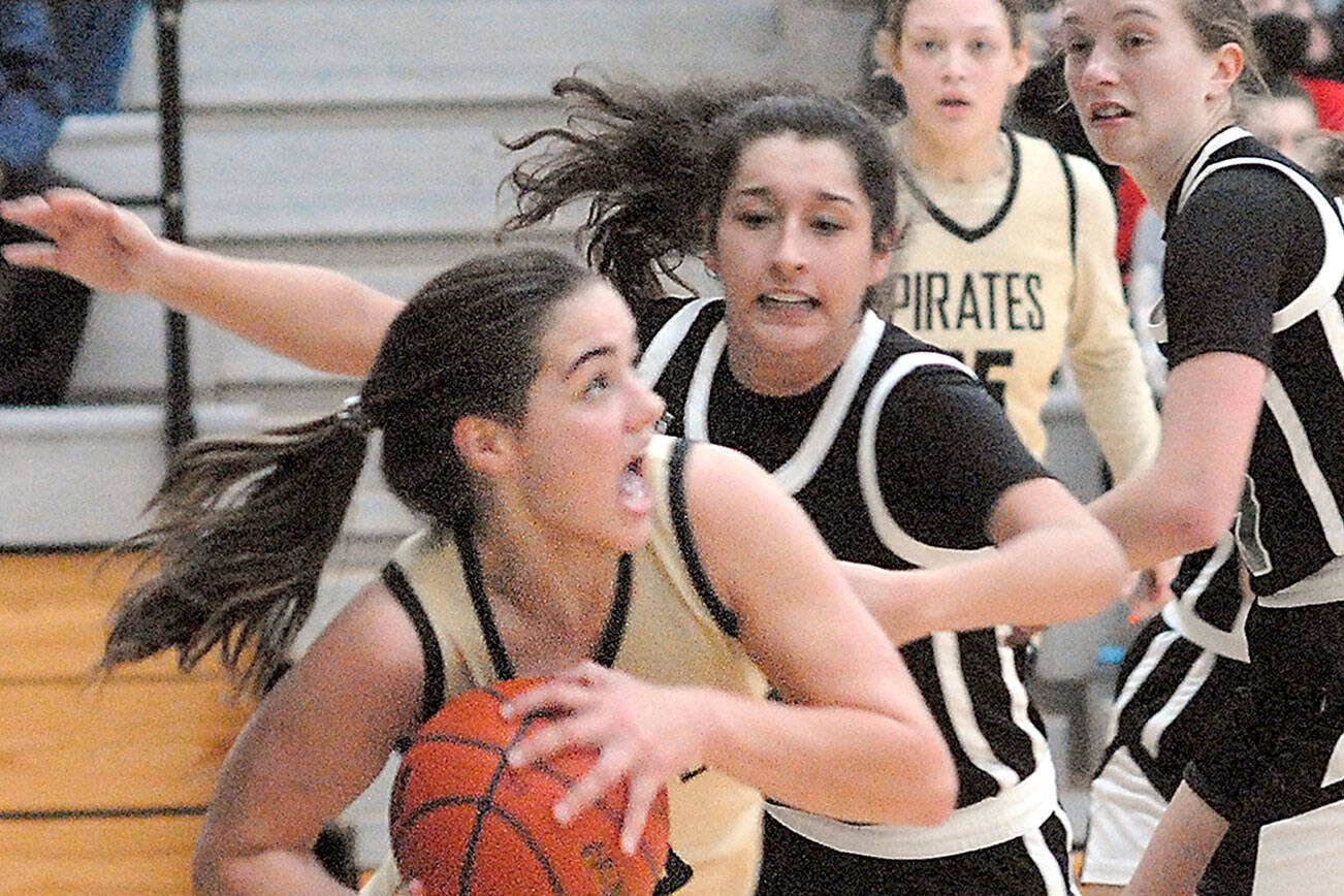 Keith Thorpe/Peninsula Daily News
Peninsula's Hope Glasser, front, looks for the basket while defended by Chemeketa's Marri-Ann Martinez and Erin Counts, right, during Saturday's game in the Pirate Classic tournament in Port Angeles. Looking on is Glasser's teammate Madison Cooke.