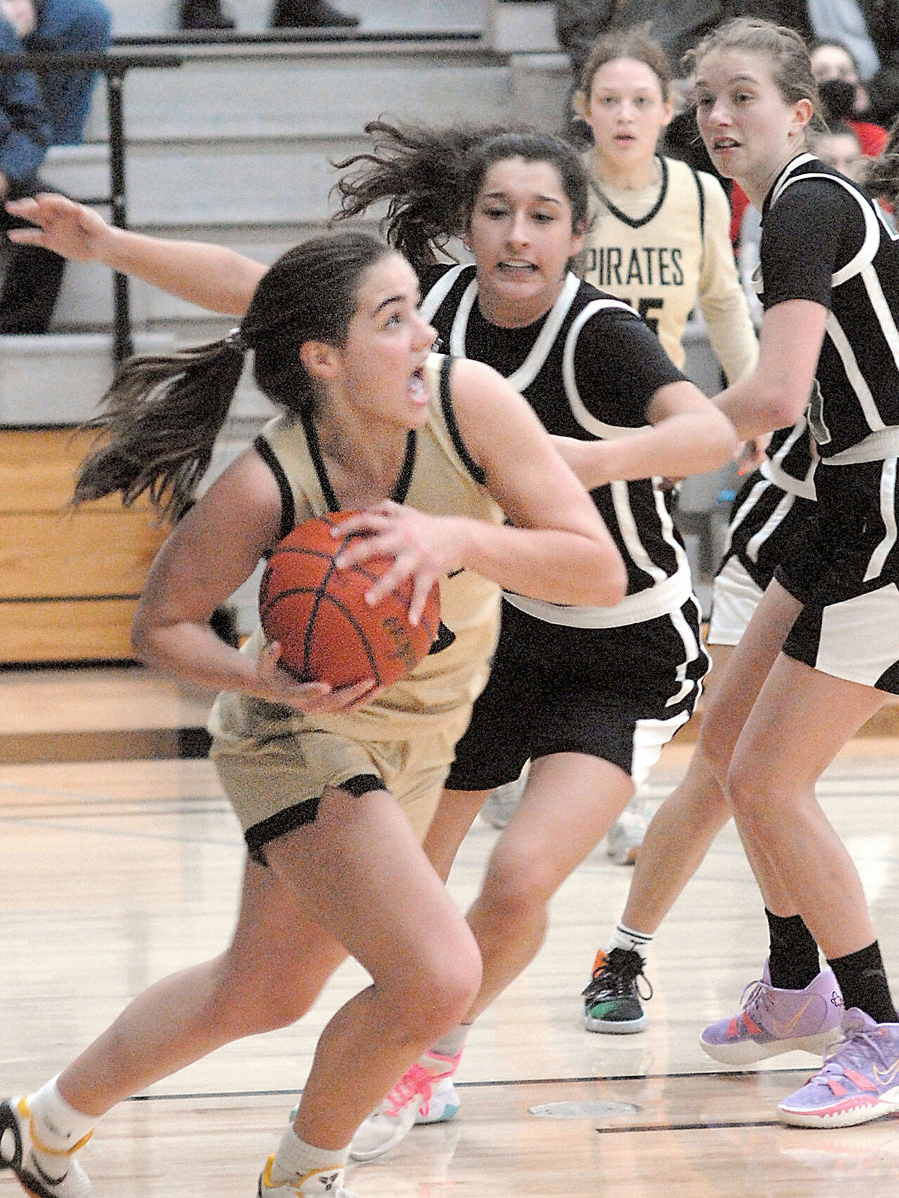 Keith Thorpe/Peninsula Daily News Peninsulas Hope Glasser, front, looks for the basket while defended by Chemeketas Marri-Ann Martinez and Erin Counts, right, during Saturdays game in the Pirate Classic tournament in Port Angeles. Looking on is Glassers teammate Madison Cooke.