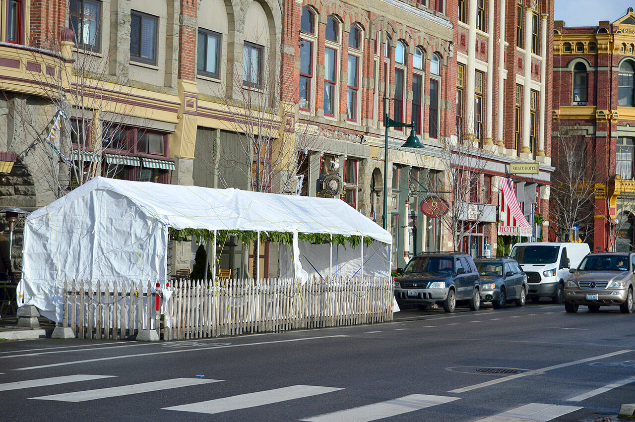 The Old Whiskey Mill’s tent on Water Street in Port Townsend is one of four “streateries” now permitted to stay up through Mother’s Day 2022. The outdoor dining enclosures, first allowed in mid-2020, have been given four extensions. (Diane Urbani de la Paz/Peninsula Daily News)