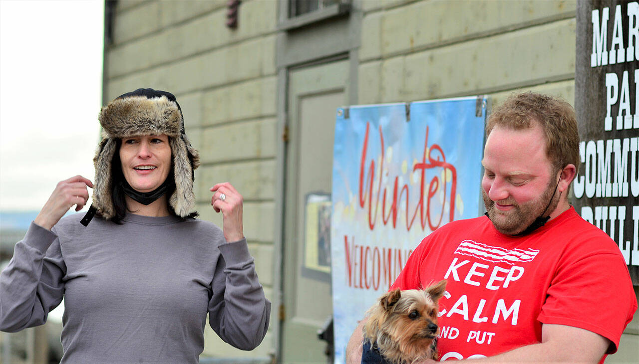 Lisa Anderson and Ben Casserd, along with Half Pint, their terrier mix, are the staff monitors at the Winter Welcoming Center. The center offers warmth, coffee, snacks, wi-fi and electricity for charging devices in the Pope Marine Building at Water and Madison streets in Port Townsend. (Diane Urbani de la Paz/Peninsula Daily News)