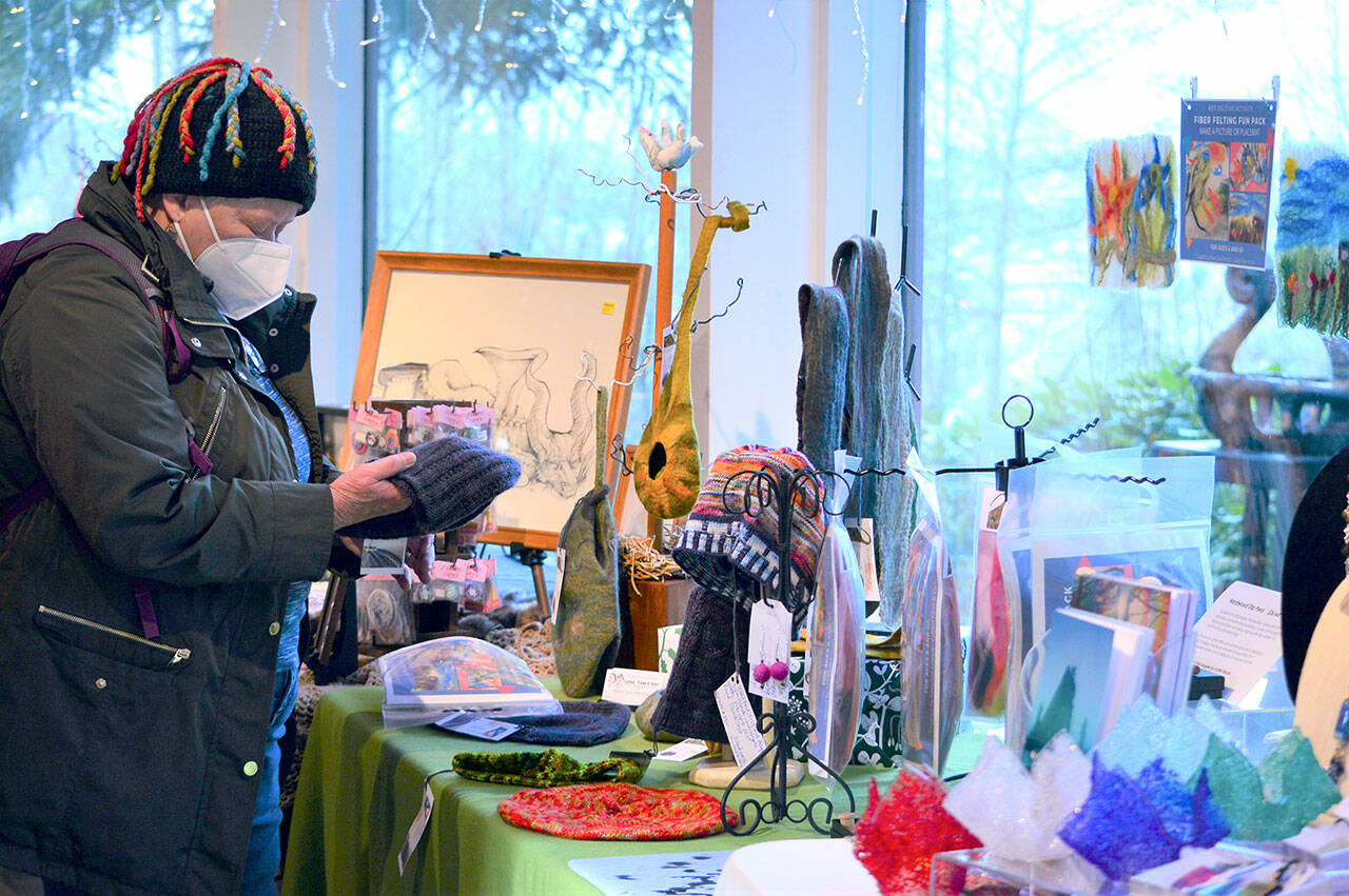 Kathleen McCowan of Seattle browses the goods at the Wintertide Makers’ Market, which wraps this Sunday at the Port Angeles Fine Arts Center. (Diane Urbani de la Paz/Peninsula Daily News)