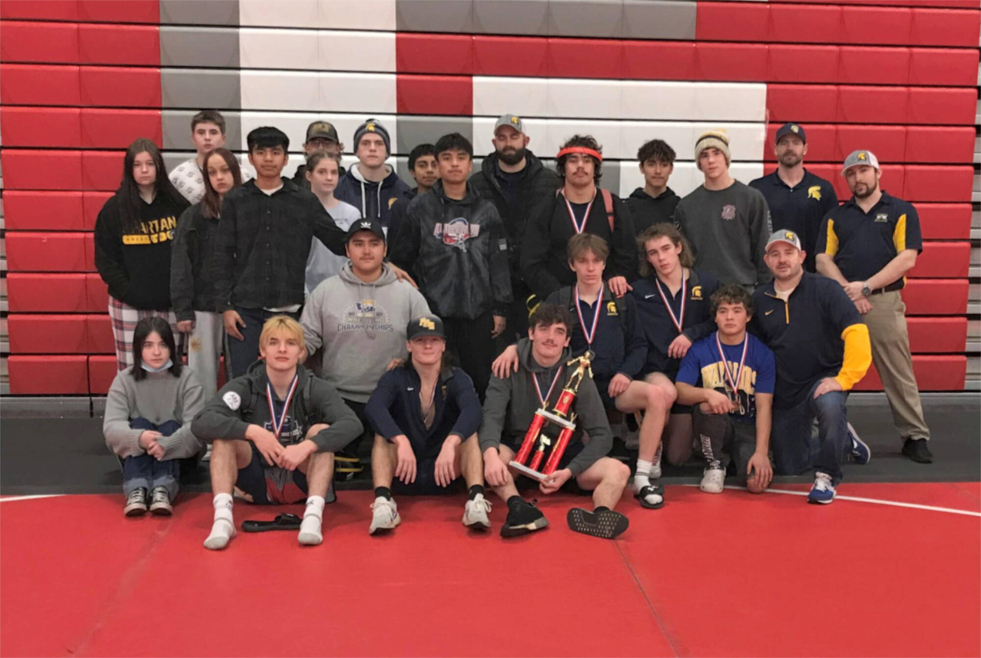 Courtesy of Forks High School
The Forks boys and girls wrestling teams celebrate their second- and fourth-place trophies at the Tony Saldiver Invitational held in Granger on Saturday.