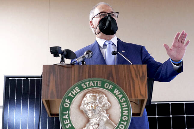Ted S. Warren / The Associated Press
Gov. Jay Inslee announces several climate-related proposals for the 2022 legislative session during a news conference Monday in Olympia, including a plan to offer rebates on new and used electric vehicles.