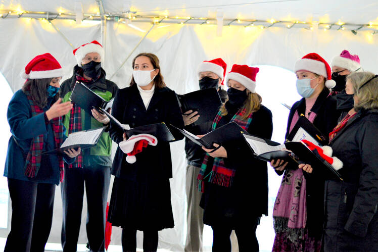 The a cappella Wild Rose Chorale, caroling in downtown Port Townsend earlier this month, will give the first in-person Candlelight Concert in 20 months this Thursday at Trinity United Methodist Church. The members are, from left, director Leslie Lewis, Doug Rodgers, Viola Frank, Al Thompson, Sarah Gustner-Hewitt, Eugenia Frank, Steve Duniho and Lynn Nowak; not pictured is Chuck Helman. (Diane Urbani de la Paz/Peninsula Daily News)