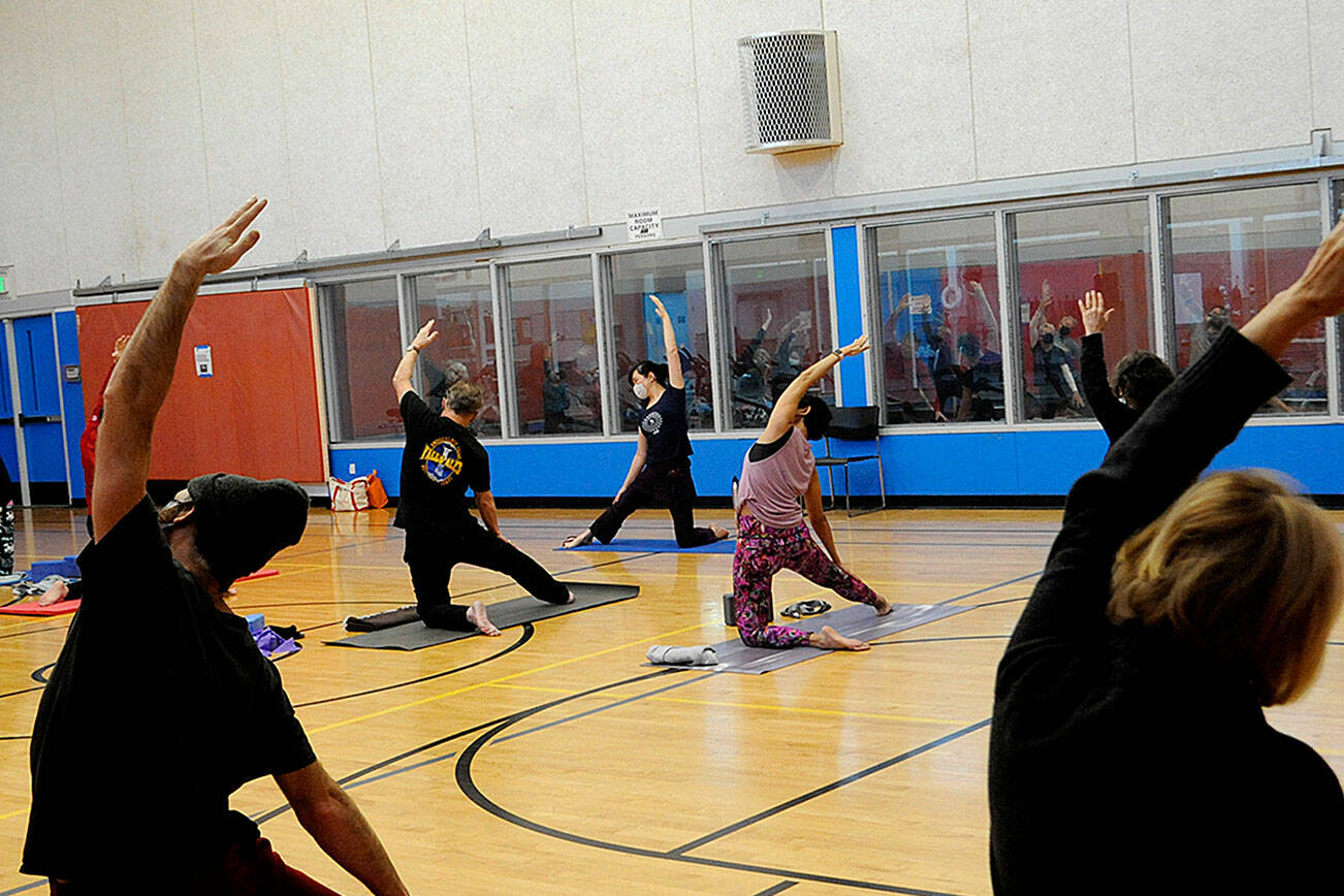 Kitty Sokkappa leads a yoga class at the YMCA of Sequim. It’s one of the biggest at the facility, staff say. Starting Jan. 1, club members and participants ages 12 and older in all North Olympic Peninsula YMCAs must provide proof of COVID-19 vaccine or a negative test before participating in events. (Matthew Nash/Olympic Peninsula News Group)
