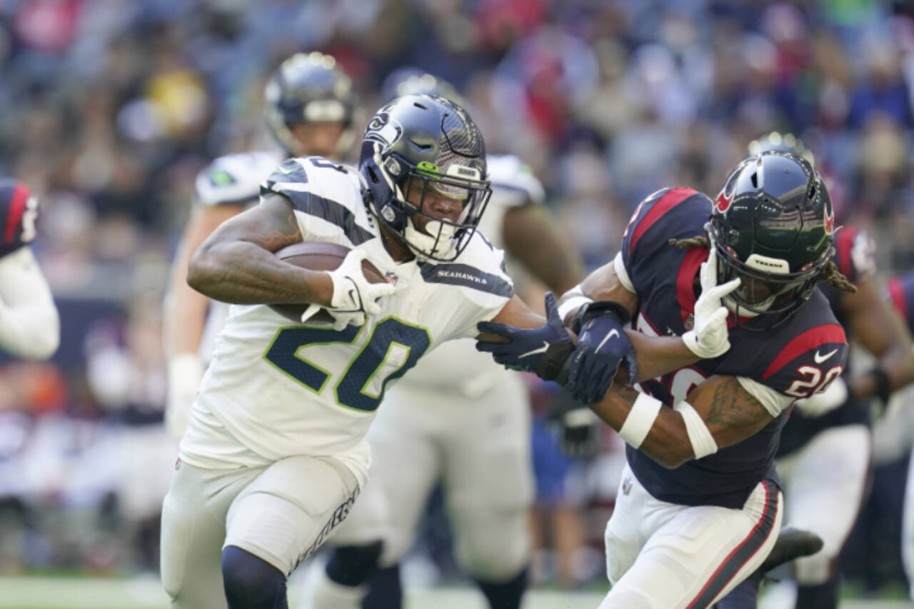 Seattle Seahawks running back Rashaad Penny (20) carries the ball during an NFL football game against the Houston Texans, Sunday, Dec. 12, 2021, in Houston. (AP Photo/Matt Patterson)