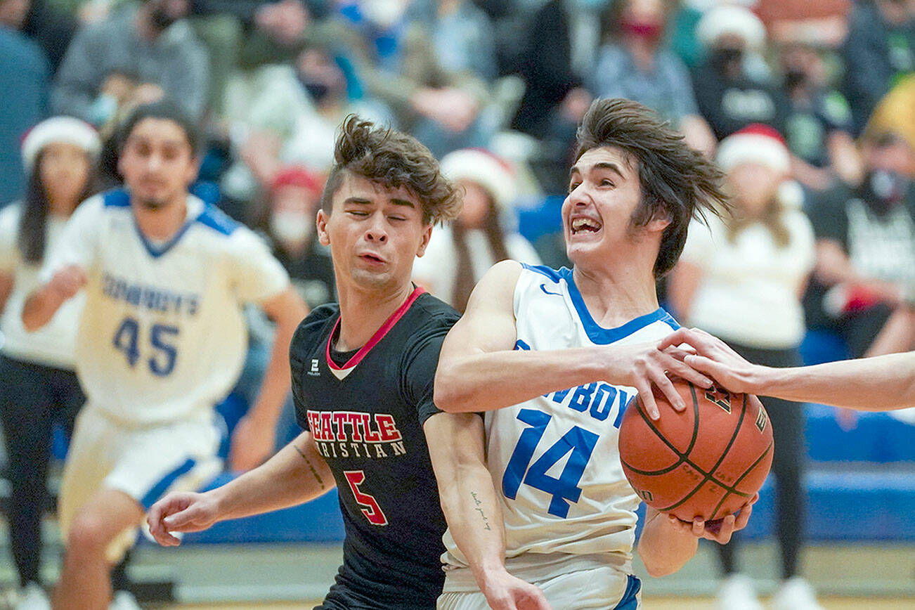 Steve Mullensky/for Peninsula Daily News

East Jefferson’s Lonnie Kenney breaks for the basket as Seattle Christian’s Hayden Hochhalter tries to break up the play during action Friday night in Chimacum.