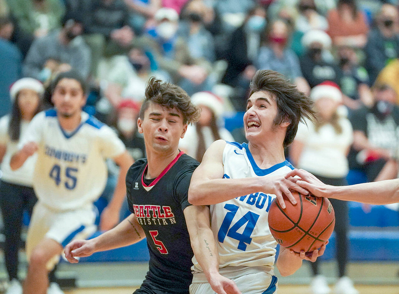 East Jefferson’s Lonnie Kenney breaks for the basket as Seattle Christian’s Hayden Hochhalter tries to break up the play during action Friday night in Chimacum. Seattle Christian won 72-41. (Steve Mullenksy/for Peninsula Daily News)