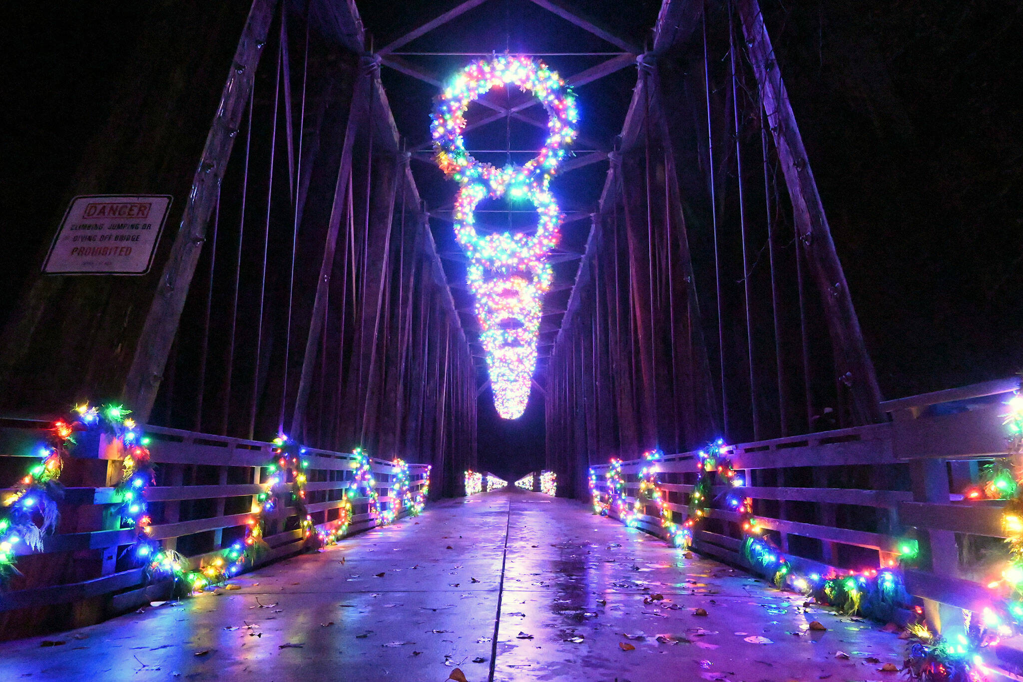 Visitors to Railroad Bridge Park enjoy the colorfully-lit historic bridge earlier this week. It’s part of a collective light display by the Jamestown S’Klallam Tribe to place 3.25 million lights around the Blyn/Dungeness/ Sequim area. (Michael Dashiell/Olympic Peninsula News Group)