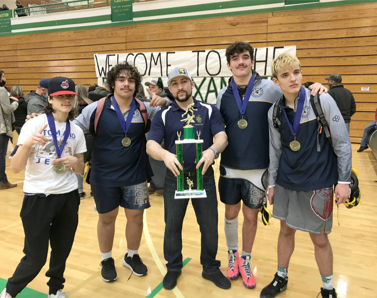 Forks individual champions Saturday at the Pat Alexander Tournament in Tumwater include from left, Matthew Montes (106 pounds), Sloan Tumaua (220 pounds), Asst. Coach Daniel Frishkorn, Hayden Queen (182 pounds) and Jake Weakley (160 pounds). (Forks wrestling team)