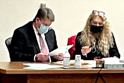 Dennis Marvin Bauer, left, speaks with his attorney, Karen Unger, before testimony in his triple-murder trial Monday at the Clallam County Courthouse. (Rob Ollikainen/For Peninsula Daily News)