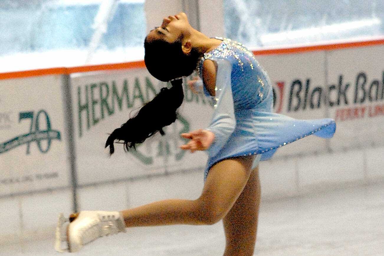 Danica Sebastian, 12, of Bremerton, a member of the Bremerton Figure Skaters Club, gives a skating demonstration on Tuesday at the Winter Ice Village in downtown Port Angeles. Club members put on a four-routine performance of songs featured in their recent holiday show in Bremerton. The Port Angeles skating rink is open daily from 9 a.m. to 9 p.m. with breaks for ice resurfacing through Jan. 3. (Keith Thorpe/Peninsula Daily News)