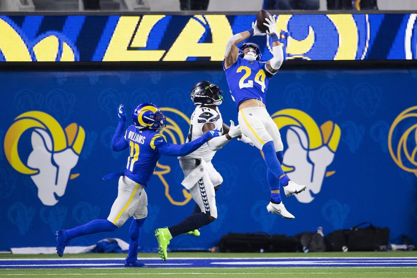 Los Angeles Rams free safety Taylor Rapp (24), a former Washington Husky, intercepts a pass intended to Seattle Seahawks wide receiver DK Metcalf (14) during an NFL football game Tuesday  in Inglewood, Calif. (Kyusung Gong/The Associated Press)