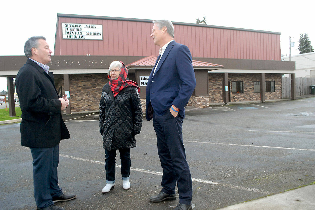 Real estate broker Jim Haguewood, left, speaks with retired businesswoman Edna Peterson and North Olympic Healthcare Network CEO Michael Maxwell outside of Ednas Place in Port Angeles after the building was acquired from Peterson by the healthcare organization. (Keith Thorpe/Peninsula Daily News)