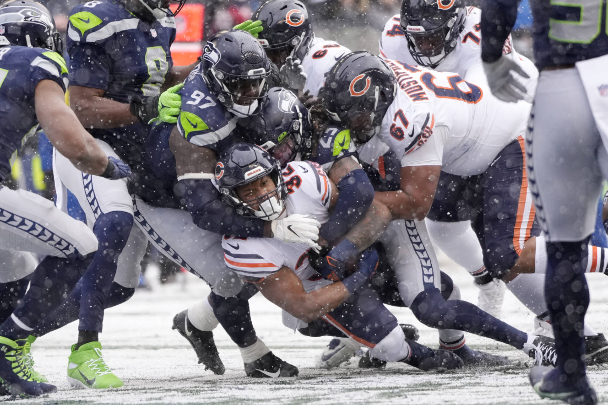 Stephen Brashear/The Associated Press
Chicago Bears running back David Montgomery, bottom, scores a touchdown on a carry against the Seattle Seahawks during the first half Sunday in snowy Seattle.