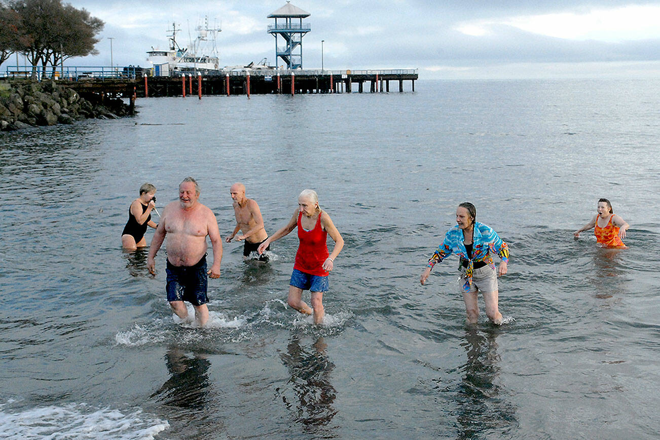 Polar Bear participants emerge from the chilly water of Port Angeles Harbor during the 2021 New Years Day plunge at Hollywood Beach, which happened despite a pandemic and the lack of an organized plan. (Keith Thorpe/Peninsula Daily News)