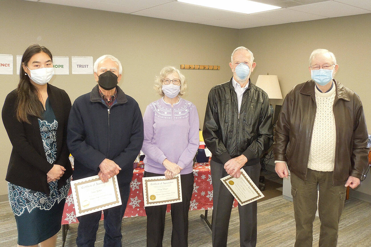 JooRi Jun, executive director for Volunteer Hospice of Clallam County, far left, and board president Peter Raiswell, far right, honor outgoing board members, in center, from left, Dave Gilbert, Nancy Bargar and Ed Hopfner. Submitted photo