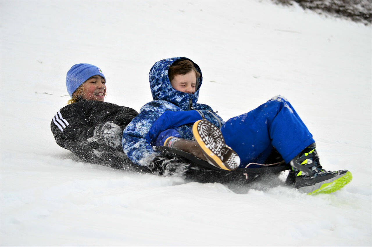 Nick Harper, left, and Elliot Mull, both 9, hurtle down High School Hill in Port Townsend on Tuesday afternoon. (Diane Urbani de la Paz/Peninsula Daily News)