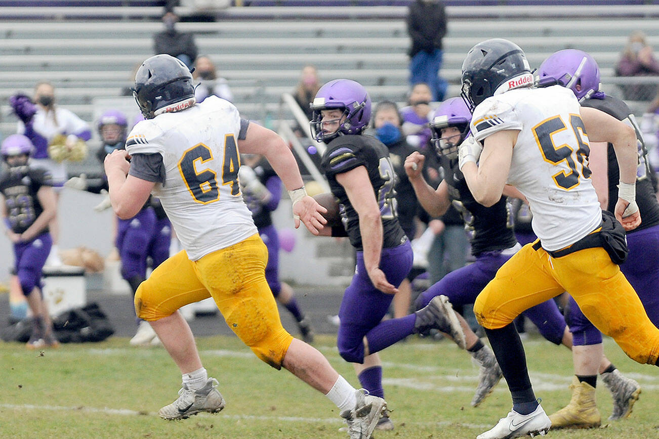 Michael Dashiell/Olympic Peninsula News Group
Sequim's Walker Ward runs with the football against Bainbridge during a February game, one of the first prep sporting events held in 11 months due to the pandemic.