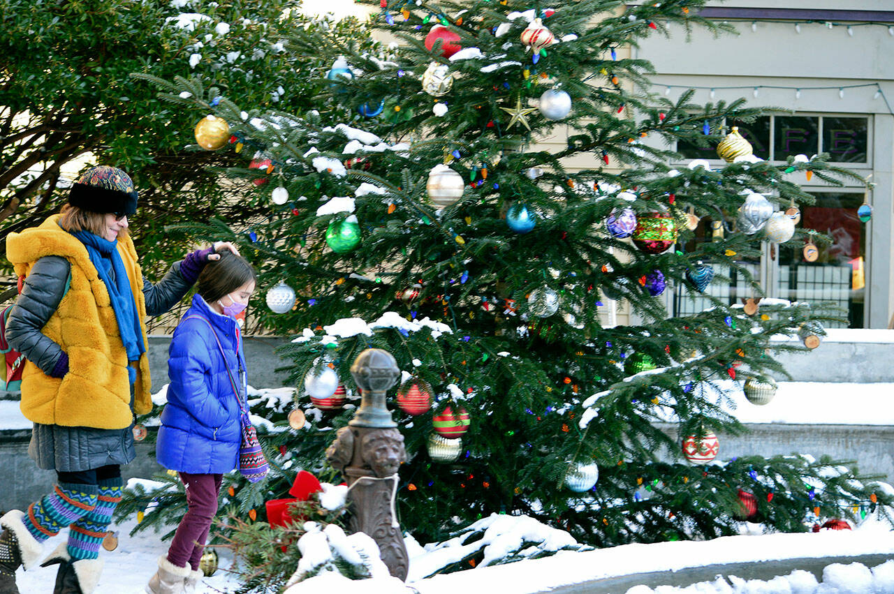 Gwen Evans and granddaughter Isla Siamas, 9, walk past the community Christmas tree in downtown Port Townsend while on their regular Thursday lunch date. (Diane Urbani de la Paz/Peninsula Daily News)