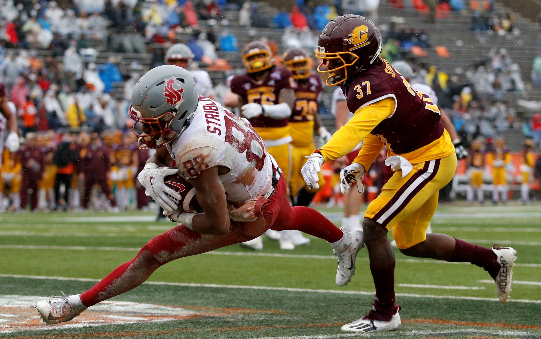 Washington State wide receiver De'Zhaun Stribling (88) catches a pass in the end zone to score a touchdown as he's defended by Central Michigan defensive back Rolliann Sturkey (37) during the second half of the Sun Bowl NCAA college football game in El Paso, Texas, Friday, Dec. 31, 2021. (AP Photo/Andres Leighton)