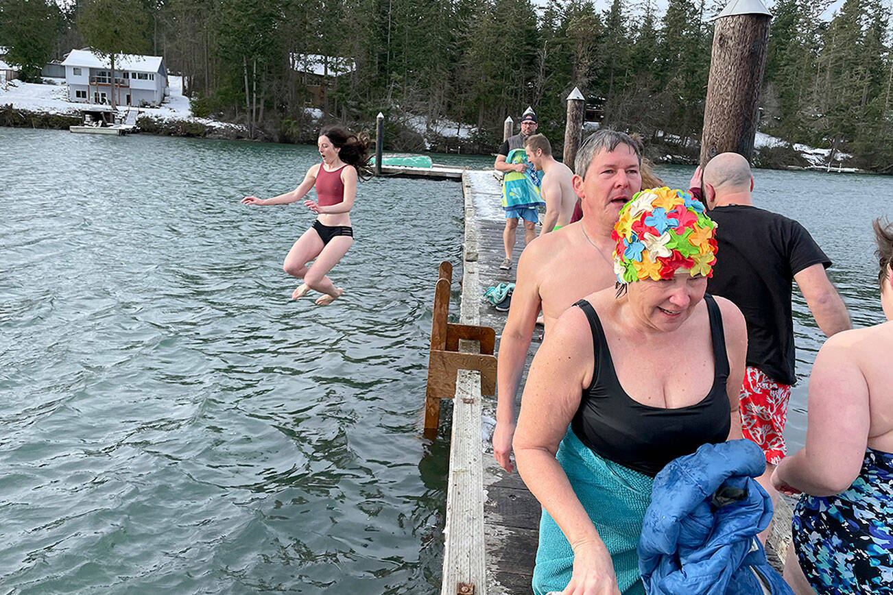 Will O’Donnell 

Theresa Britschg of Seattle and and Chuck Sparks of Marrowstone Island walk back to the Nordland General Store after jumping into the chilly waters of Mystery Bay off the dock outside the store on Saturday. Behind them, Anna Watt of Marrowstone Island is captured in mid-jump. Other polar bear plunges on New Year’s Day on the North Olympic Peninsula were in Port Angeles and at Lake Pleasant.