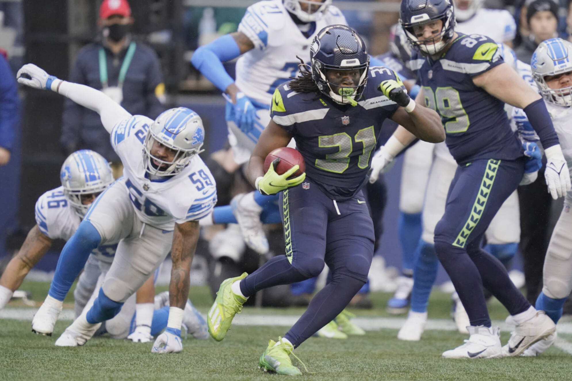 Seattle Seahawks running back DeeJay Dallas (31) runs the ball against the Detroit Lions during the first half of an NFL football game, Sunday, Jan. 2, 2022, in Seattle. (AP Photo/Elaine Thompson)
