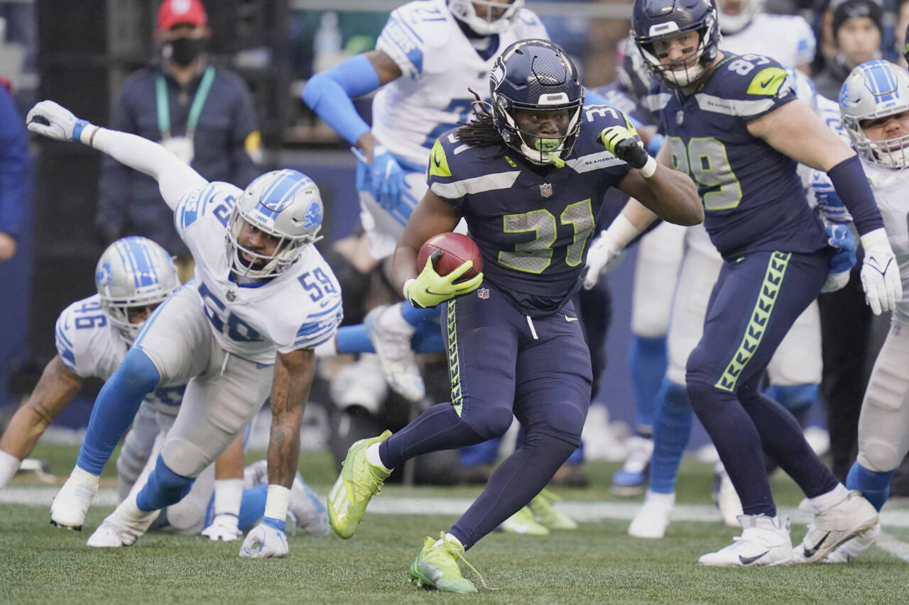 Seattle Seahawks running back DeeJay Dallas (31) runs the ball against the Detroit Lions on Sunday in Seattle. (AP Photo/Elaine Thompson)