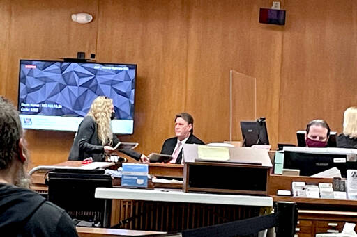Dennis Bauer is questioned by defense attorney Karen Unger during his triple-murder trial in Clallam County Superior Court on Monday. (Rob Ollikainen/For Peninsula Daily News)