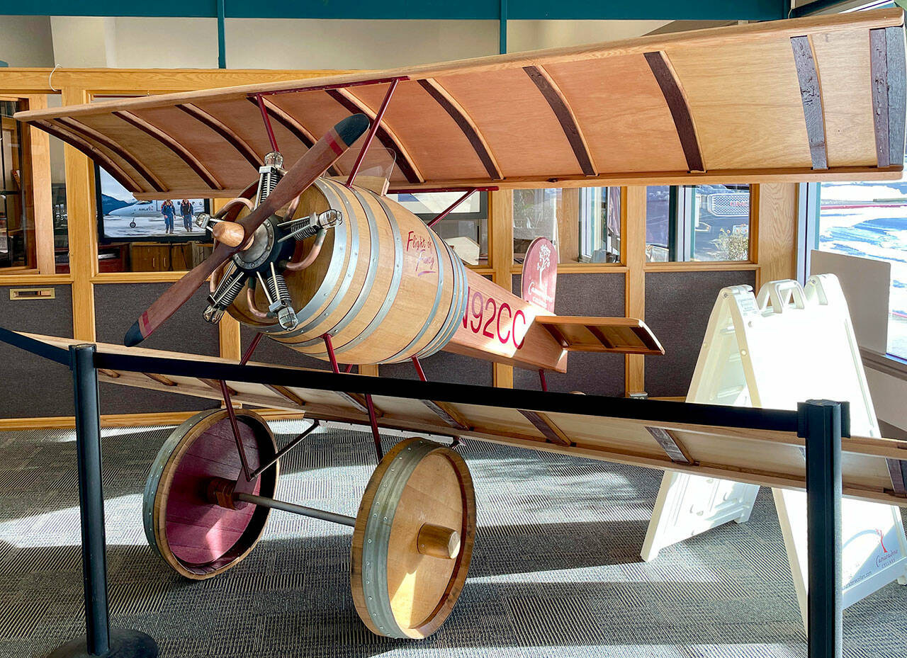 Visitors at Fairchild International Airport have something new to buzz about. Located inside at the entrance of the Airport Terminal Building, Flight of Fancy, created by Gene Unger and his partner Don Corson of Camaraderie Cellars Winery, features a handmade aircraft constructed out of parts of wine barrels. The tail number N92CC represents the first vintage year of the winery, 1992. (Scott Gardinier/Peninsula Daily News)