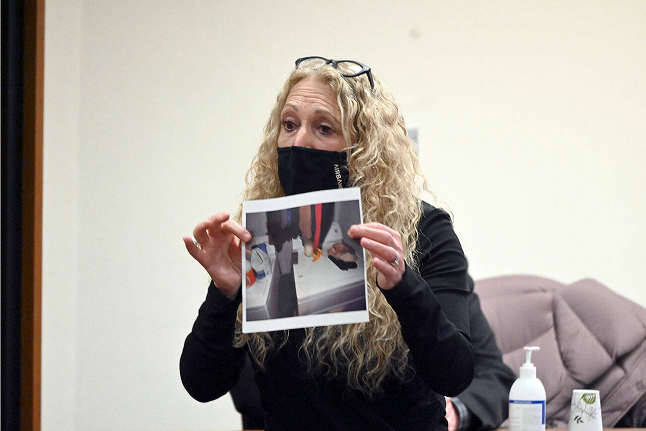 Paul Gottlieb/Peninsula Daily News
Karen Unger, attorney for accused triple-murderer Dennis Bauer, shows a photo to the jury Thursday during closing arguments that shows bullet casing found on the dryer of victim Darrell Iverson.