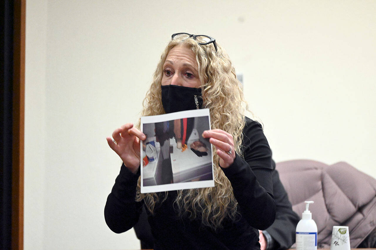 Paul Gottlieb/Peninsula Daily News
Karen Unger, attorney for accused triple-murderer Dennis Bauer, shows a photo to the jury Thursday during closing arguments that shows bullet casing found on the dryer of victim Darrell Iverson.