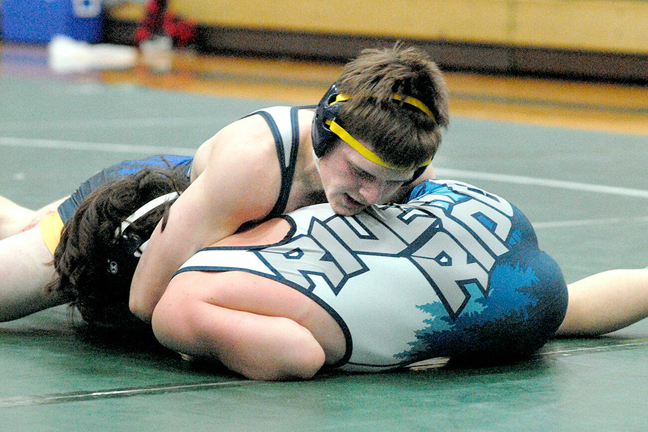 Keith Thorpe/Peninsula Daily News
Kaleb Blanton of Forks, top, takes on River Ridge's Collin Andrews in the 152-lb. class on Saturday in Port Angeles.