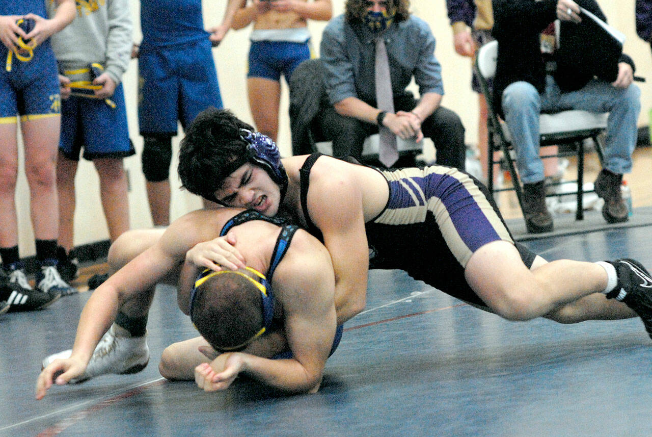Keith Thorpe/Peninsula Daily News Aaron Tolberg of Sequim, top, wrestles with Nicholas Hawkins of Fife in the 152-lb. class on Sataurday at Port Angeles High School.