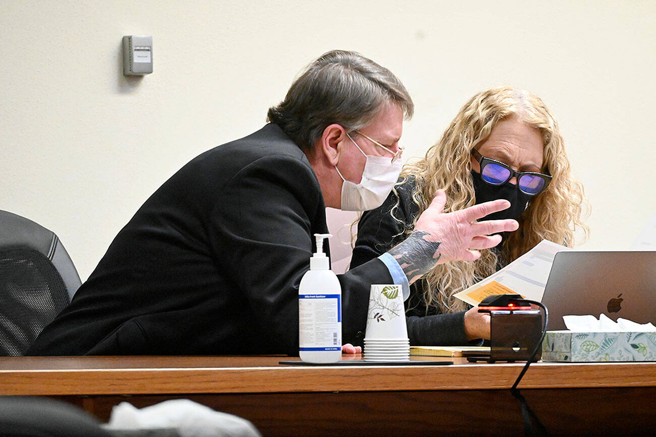 Paul Gottlieb/Peninsula Daily News

Dennis Bauer confers with lawyer Karen Unger.