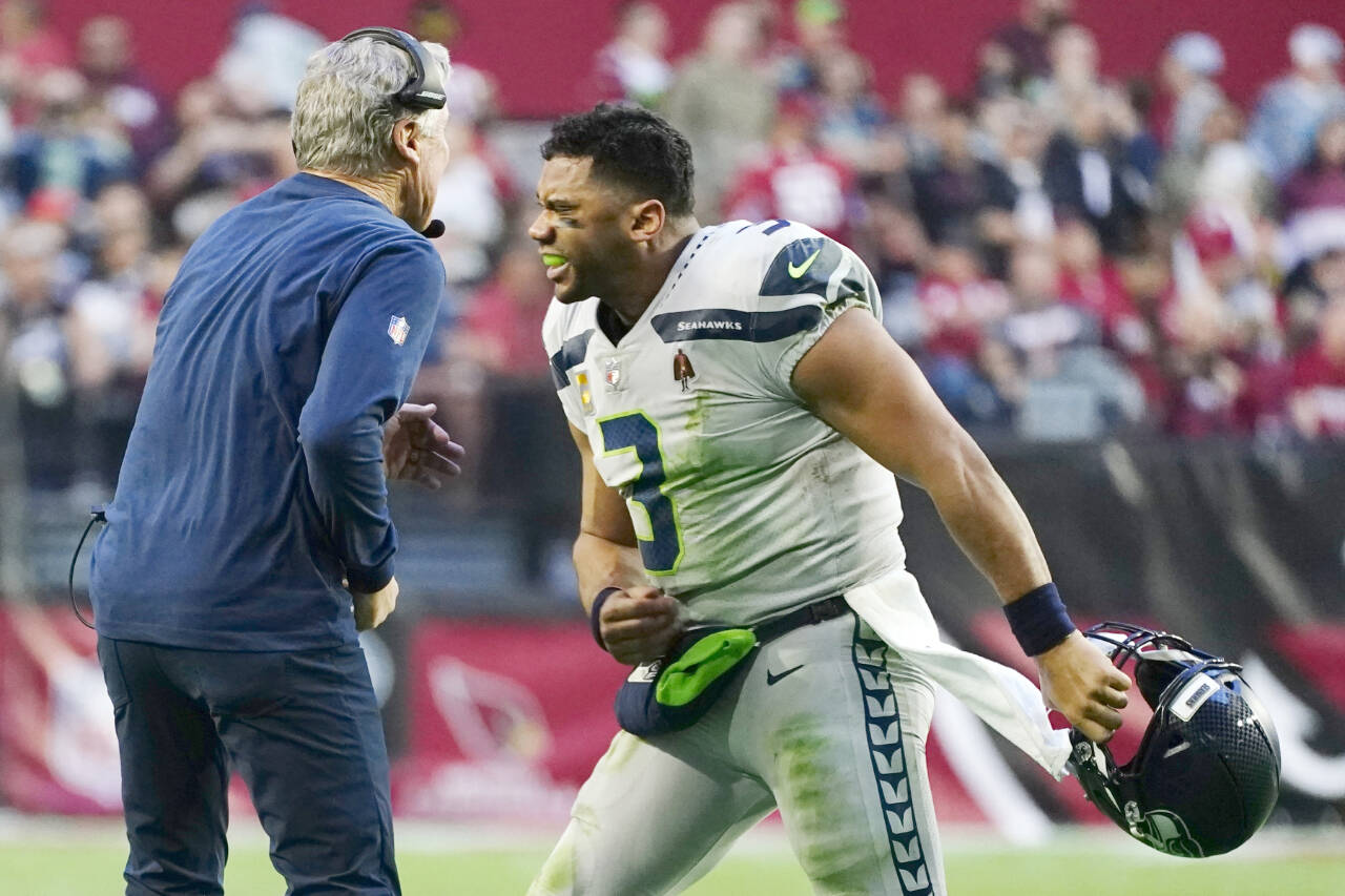 Seattle Seahawks quarterback Russell Wilson (3) celebrates a touchdown against the Arizona Cardinals with Seahawks head coach Pete Carroll, left, during the second half of an NFL football game Sunday, Jan. 9, 2022, in Glendale, Ariz. (AP Photo/Ralph Freso)