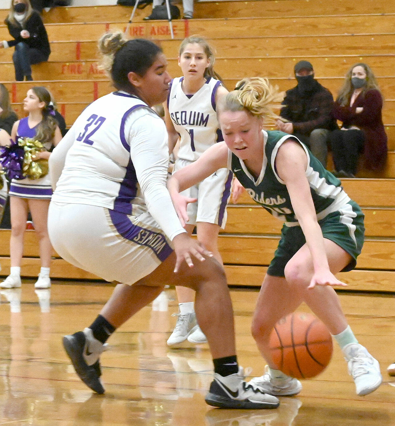 Michael Dashiell/Olympic Peninsula News Group Port Angeles’ Anna Petty dribbles inside while defended by Sequim’s Jelissa Julmist during the Wolves’ 60-55 victory Tuesday.
