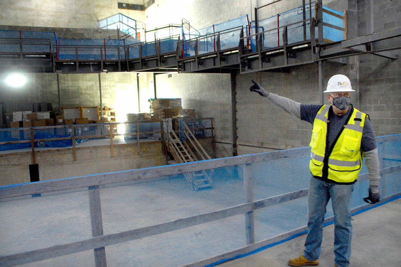 Project Director Chris Fidler stands on the stage of the Field Arts & Events Hall’s performance venue in March 2021. (Keith Thorpe/Peninsula Daily News file)